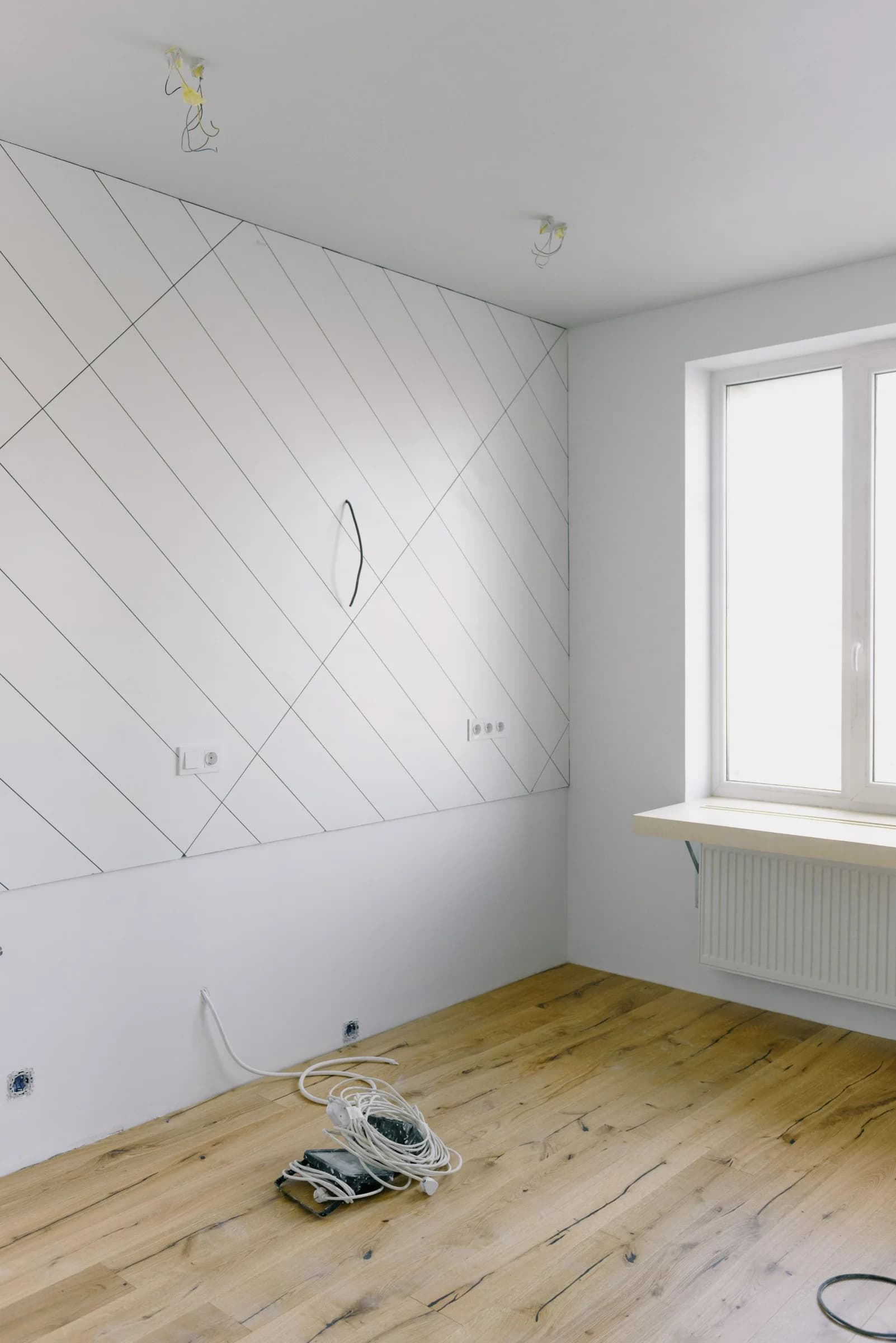 A newly finished room with bare floors and trailing cables before the final clean